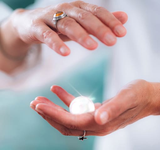 Hands with pearl - your healing journey begins here